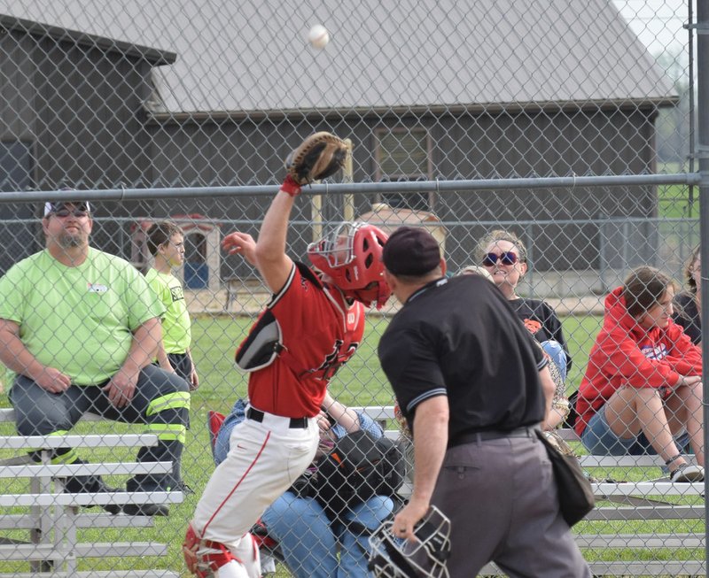 RICK PECK/SPECIAL TO MCDONALD COUNTY PRESS McDonald County catcher Joe Brown catches a foul pop-up during the Mustangs' 8-6 win on April 16 at East Newton High School.