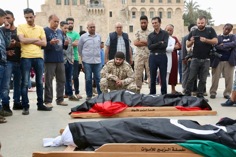 Mourners gather for funeral prayers for fighters killed by warplanes of Field Marshal Khalifa Hifter's forces, Wednesday, April 24, 2019 in Tripoli, Libya. A top Russian diplomat has called on the self-styled Libyan National Army to cease fire and stop its advance on the Libyan capital.(AP Photo/Hazem Ahmed)