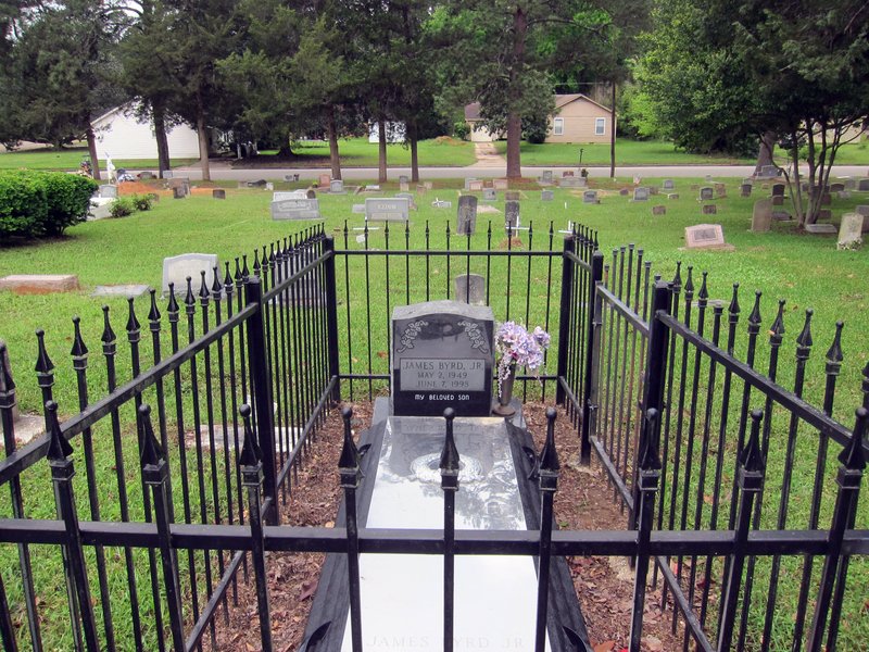 This April 12, 2019, photo shows the gravesite of James Byrd Jr. in Jasper, Texas. Byrd was killed on June 7, 1998, after he was chained to the back of a pickup truck and dragged for nearly three miles along a secluded road in the piney woods outside Jasper in what is considered one of the most gruesome hate crime murders in recent Texas history. (AP Photo/Juan Lozano)