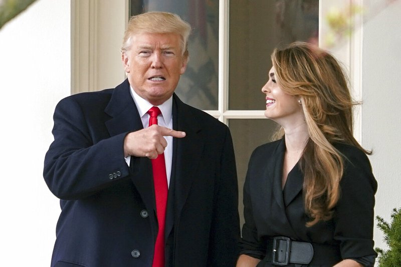 In this March 29, 2018 file photo, President Donald Trump points to outgoing White House Communications Director Hope Hicks on her last day before he boards Marine One on the South Lawn of the White House in Washington. The report of special counsel Robert Mueller shined a light on the much-discussed meeting of Donald Trump Jr., Jared Kushner and campaign officials with several people linked to Russia. When Kushner brought emails about that meeting to the White House, the president's communications director didn't sugarcoat her opinion: She told Donald Trump the emails were "really bad." (AP Photo/Andrew Harnik)
