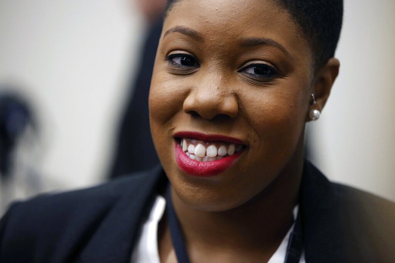 In this Jan. 11, 2016 file photo, Symone Sanders speaks to members of the media in the spin room after a presidential forum in Des Moines, Iowa. Joe Biden has hired Symone Sanders, a prominent African American political strategist, as a senior adviser to his newly launched presidential campaign. (AP Photo/Andrew Harnik)