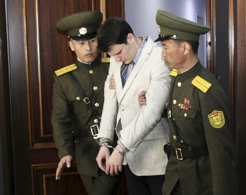 North Korean officers carry Otto Warmbier into court on March 16, 2016, where he was sentenced to 15 years of hard labor. He fell into a coma that night for reasons that were never explained.
