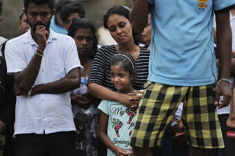 The mother and sister of Dhami Brandy, 13, mourn at her funeral Thursday in Negombo, Sri Lanka. Dhami was among the victims of Easter Sunday’s bombing at St. Sebastian Church.