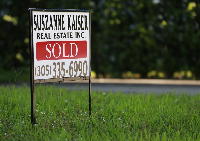 In this Friday, April 12, 2019 photo, a sold sign is shown in front of a home in Surfside, Fla. On Thursday, April 25, Freddie Mac reports on this week&#x2019;s average U.S. mortgage rates.(AP Photo/Wilfredo Lee)