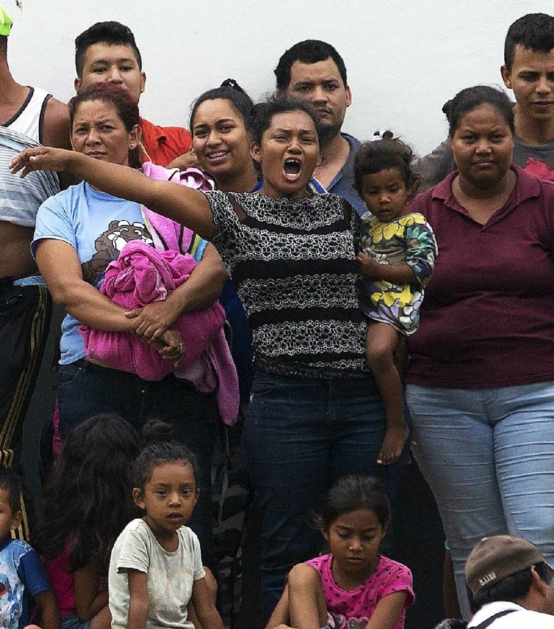 Migrants at a detention center in Tapachula in Mexico’s Chiapas state demonstrate Friday to demand better conditions or transfer to another facility. The surge of families arriving at the U.S. border is pushing plans for expanding the military’s role in dealing with the overwhelming numbers. 