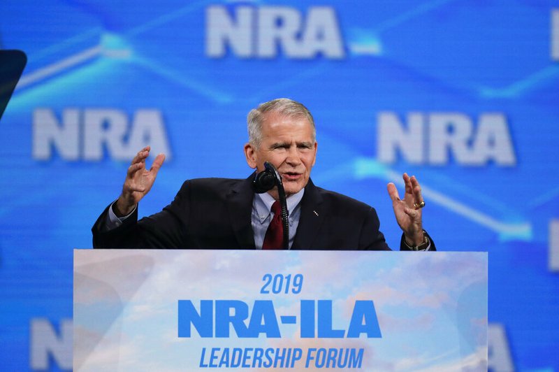 In this Friday, April 26, 2019 photo, National Rifle Association President Col. Oliver North speaks at the National Rifle Association Institute for Legislative Action Leadership Forum in Lucas Oil Stadium in Indianapolis. On Saturday, North announced that he will not serve a second term as the president of the NRA amid inner turmoil in the gun-rights group. (AP Photo/Michael Conroy)