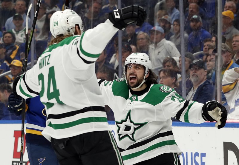 Dallas Stars' Roope Hintz, of Finland, is congratulated by Mats Zuccarello, right, after scoring during the first period in Game 2 of an NHL second-round hockey playoff series against the St. Louis Blues Saturday, April 27, 2019, in St. Louis. (AP Photo/Jeff Roberson)