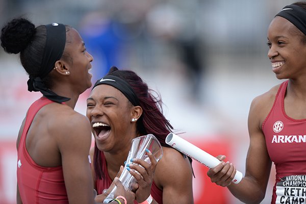 Arkansas runners Janeek Brown (left), Kiara Parker (center) and Kethlin Campbell celebrate after winning the 400-meter relay during the National Relay Championships on Saturday, April 27, 2019, in Fayetteville.