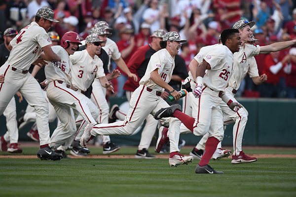 Arkansas players celebrate after defeating Tennessee in 10 innings Sunday, April 28, 2019, in Fayetteville. 