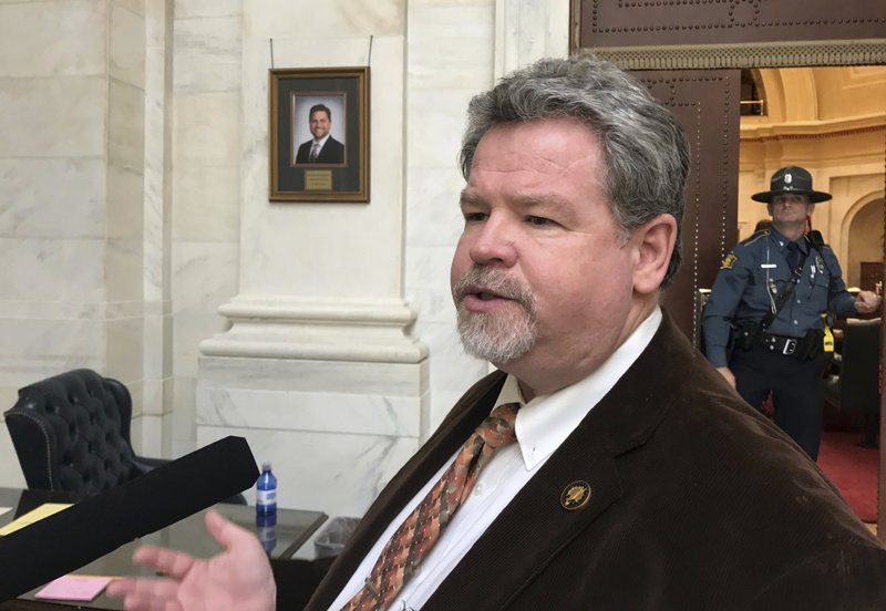 FILE - In this March 6, 2018 file photo, Republican state Sen. Alan Clark talks to reporters at the Arkansas Capitol in Little Rock, Ark. Arkansas was one of the first states to cap how long someone can serve in the Legislature nearly three decades ago, but competing term limit measures on the ballot next year could test just how far voters are willing to go in limiting lawmakers' time in office. &quot;This is just about good government,&quot; said Clark, who sponsored the legislative-backed proposal that'll go before voters next year.(AP Photo/Andrew DeMillo, File)