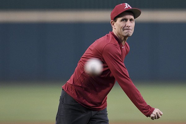 New Arkansas basketball coach Eric Musselman throws the ceremonial first pitch prior to the Razorbacks' baseball game against Mississippi State on Thursday, April 18, 2019, in Fayetteville.