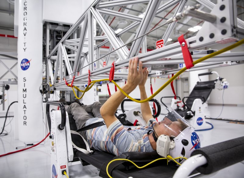 The writer tries out the microgravity simulator in the Astronaut Training Experience at Kennedy Space Center. Photo by Patrick Connolly via Orlando Sentinel (TNS)