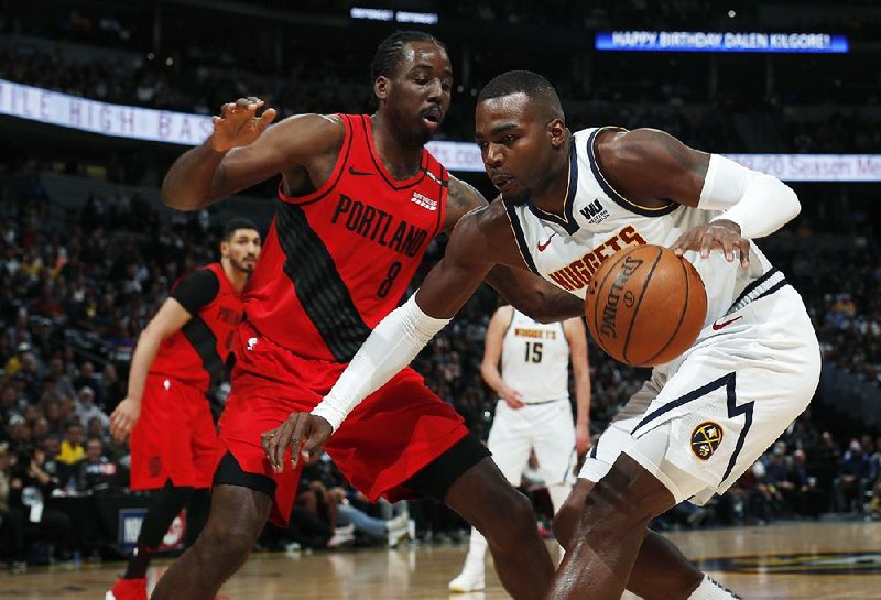 Al-Farouq Aminu (8) of the Portland Trail Blazers defends against Paul Millsap of the Denver Nuggets during the Blazers’ victory in Game 2 of their NBA playoff series Wednesday night in Denver. 