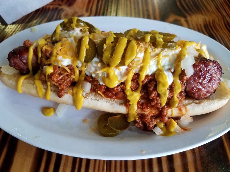 The Super Duper Whopper Dog at Woodland Bakery &amp; Bistro in Sherwood is a foot-long Polish sausage covered with chili, slaw, mustard, cheese, onion and jalapenos. Special to the Democrat-Gazette/Ann Blaylock
