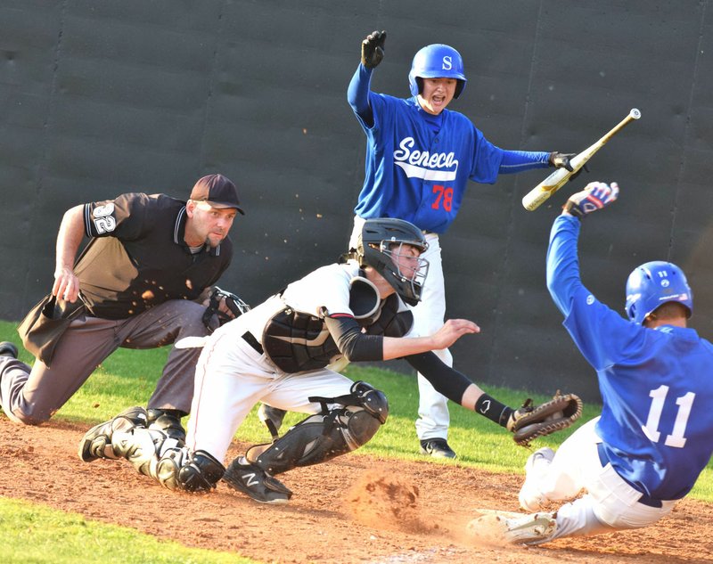 RICK PECK/SPECIAL TO MCDONALD COUNTY PRESS Seneca Daythen Long (11) narrowly avoids a tag by McDonald County catcher Kameron Hopkins during the Indians' 8-3 win on April 25 at MCHS.