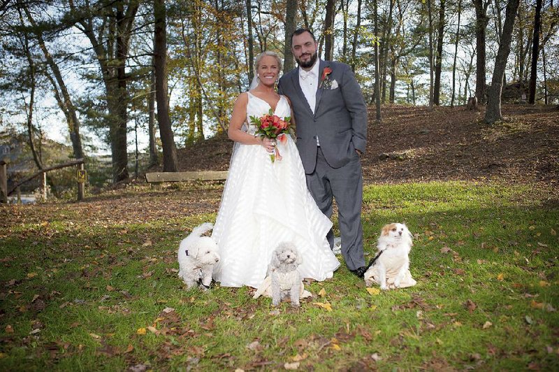 Kelly Curry and Patrick St. Onge pose with their dogs (from left) Charlie, Izzy and Zoey for a photo during their wedding day on Oct. 27, 2017, in Haddam, Conn. It’s no longer unusual for brides and grooms to include pets in their wedding photos or even in the ceremony, but it can be tough to manage that along with everything else. 