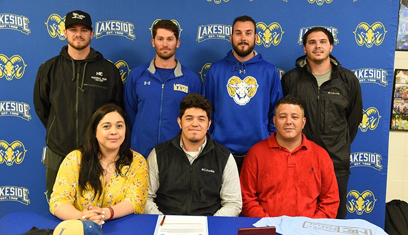 Submitted photo NIGHTHAWK INFIELDER: Lakeside senior infielder Jesus Minjarez, center, poses after signing a letter of intent to play baseball at National Park College next year in a ceremony outside the cafeteria Thursday. Minjarez was joined by his mother Cindy, left, father Manuel, NPC head baseball coach Dillon Hargrove, standing, left, Lakeside head coach Leighton Hardin and assistant coaches Bryan Bolt and Garrett Bock.
