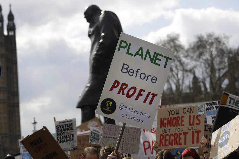  In this Friday, April 12, 2019 file photo, climate change demonstrators hold banners in front of the Winston Churchill Statue during a protest near Parliament in London.  (AP Photo/Kirsty Wigglesworth, file)