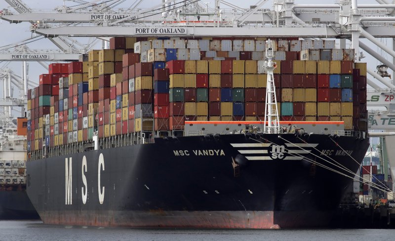 In this Jan. 28, 2019, file photo a container ship is unloaded at the Port of Oakland in Oakland, Calif. On Thursday, May 2, the Labor Department issued revised data on productivity in the first quarter. (AP Photo/Ben Margot, File)