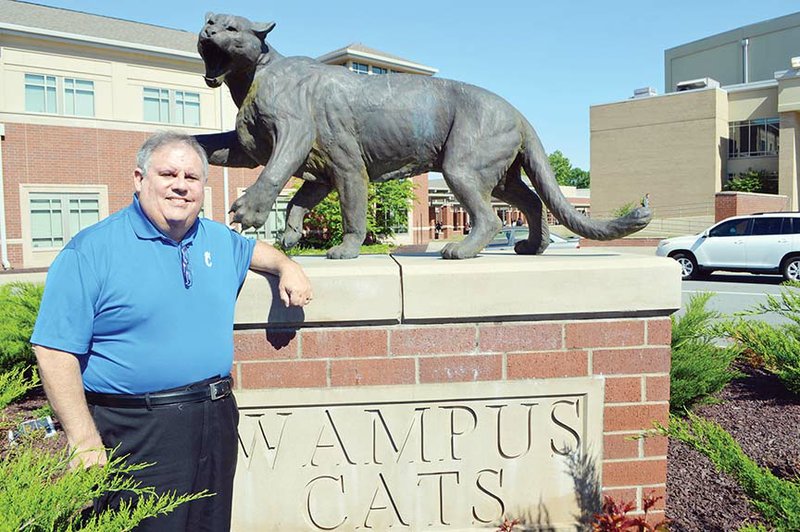 Mike Woodrum stands with the Wampus Cat statue at Conway High School. Woodrum, who retired in 2016 as supervisor of the district’s James H. Clark Auditorium, is marking his 15th year announcing CHS graduates. Graduation for the 676 seniors is scheduled for 3 p.m. May 19 at Verizon Arena in North Little Rock.