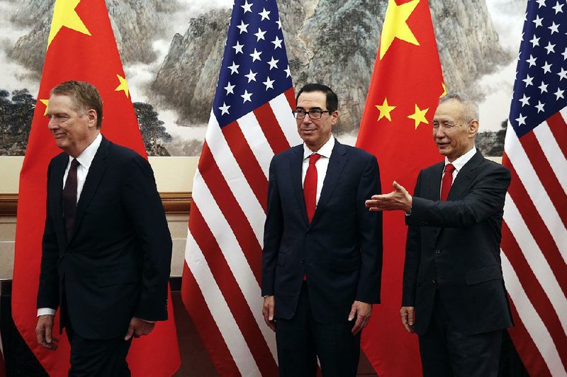 U.S. trade negotiator Robert Lighthizer (left), Treasury Secretary Steve Mnuchin and Chinese Vice Premier Liu He head into a trade-talk session earlier this week in Beijing. 