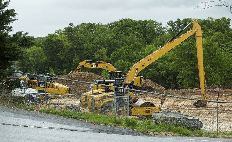Construction equipment sits Friday at the site of the stump-dump fire in Bella Vista.