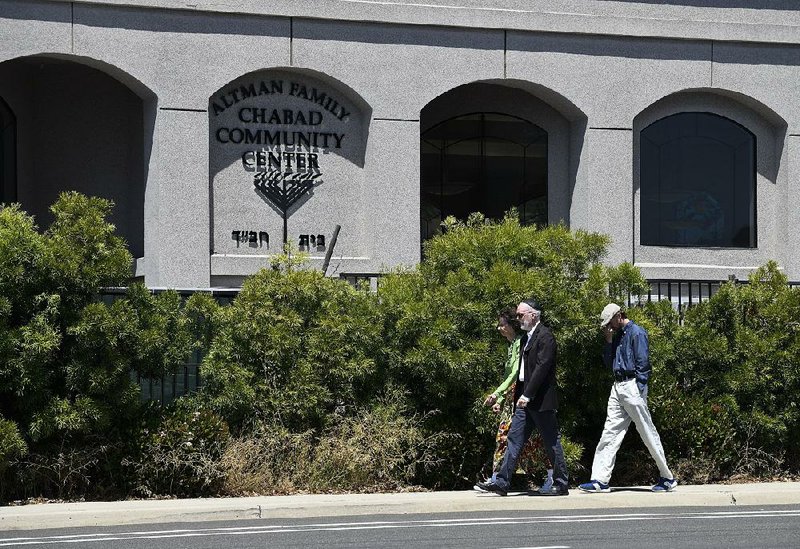 Synagogue members walk outside of the Chabad of Poway Synagogue in Poway, Calif., where a shooting on April 27 killed one congregation member and injured several others. 
