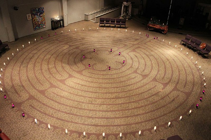 Candles dot the perimeter of the labyrinth at Pulaski Heights United Methodist Church in Little Rock. The church was one of many houses of worship around the globe open for the 11th annual World Labyrinth Day, the theme of which is “Walk as One at 1.” 