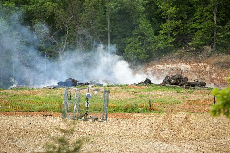 NWA Democrat-Gazette/BEN GOFF &#8226; @NWABENGOFF Smoke rises from the underground fire Friday at the stump dump site in Bella Vista.