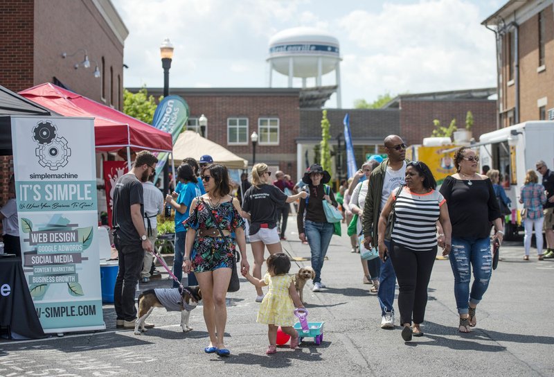 File Photo/NWA Democrat-Gazette/BEN GOFF @NWABENGOFF Guests stroll through the 'Local Lane' area May 5, 2018, during the Bentonville Film Festival.