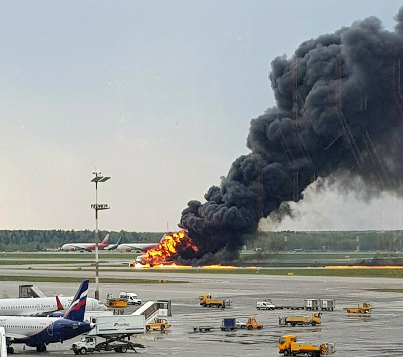 In this image provided by Riccardo Dalla Francesca, smoke rises from a fire on a plane at Moscow's Sheremetyevo airport on Sunday, May 5, 2019. (Riccardo Dalla Francesca via AP)