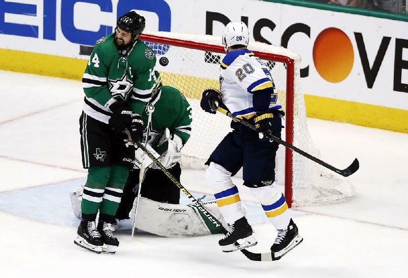 St. Louis’ Alexander Steen (20) watches as teammate Colton Parayko’s shot slips past Dallas’ Jamie Benn (14) and hits Stars goaltender Ben Bishop during the third period of Game 6 of their NHL second-round playoff series Sunday in Dallas. Bishop was injured on the play, leading to a goal by the Blues’ Jaden Schwartz.