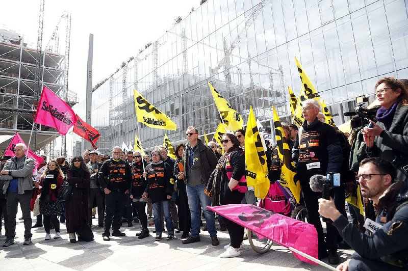French union members demonstrate in Paris at the start of the trial of French telecom giant Orange, with seven former or current managers accused of moral harassment over a wave of employee suicides a decade ago. 