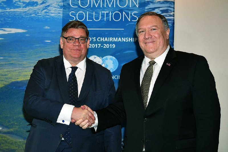 Finland’s Foreign Minister Timo Soini (left) greets Secretary of State Mike Pompeo as he arrives for the Arctic Council ministers’ working dinner at the Arktikum museum in Rovaniemi, Finland, on Monday. 