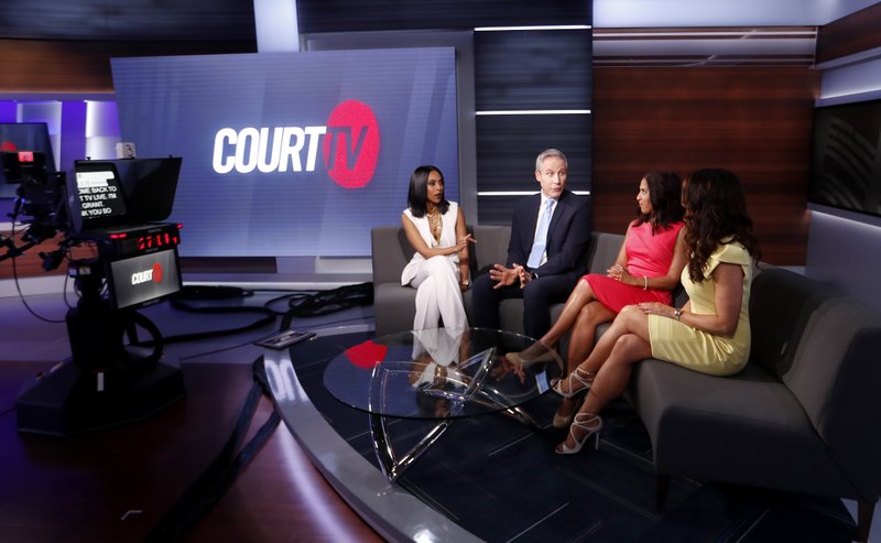 In this Thursday, May 2, 2019, photo, Court TV anchors from left, Yodit Tewolde, Vinnie Politan , Seema Iyer and Julie Grant discuss a court case as they rehearse on the set, in Atlanta. (AP Photo/John Bazemore)

