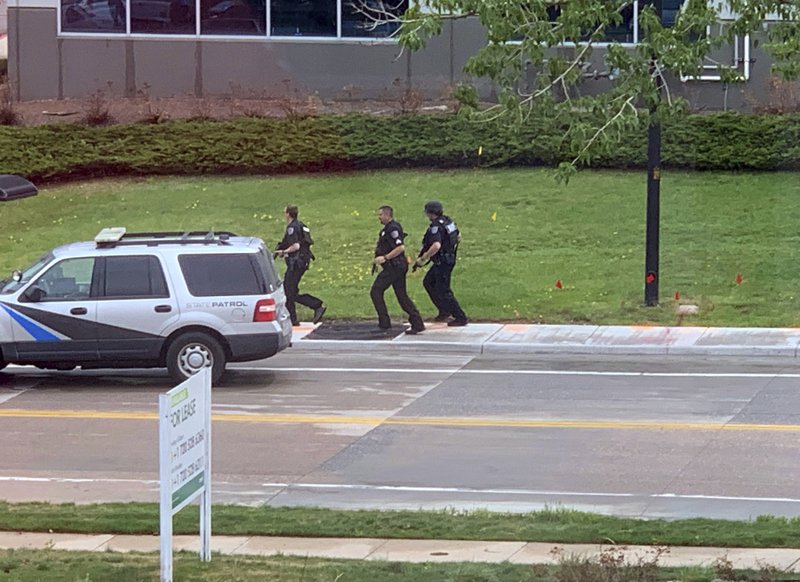 Armed police officers and others are seen outside STEM School Highlands Ranch, a charter middle school in the Denver suburb of Highlands Ranch, Colo., after a shooting Tuesday, May 7, 2019. Authorities said several people were injured and a few suspects were in custody. (Courtney Harper via AP)

