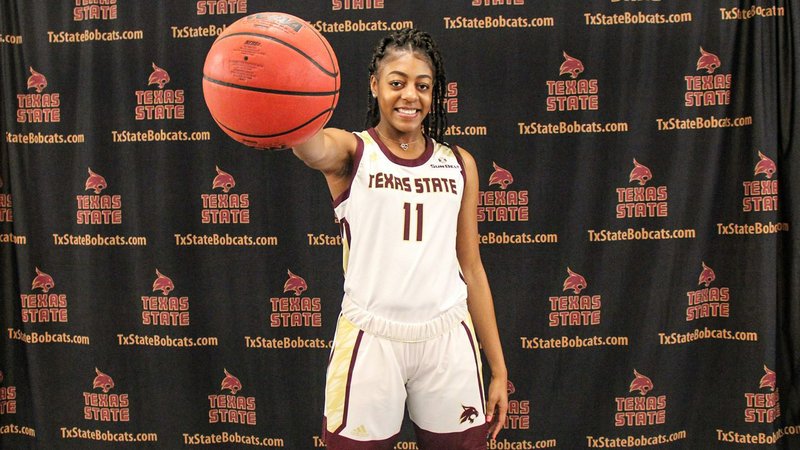 Former Magnolia Lady Panther Lillie Moore, who led Kansas City Kansas Community College to a  national championship two months ago, is now part of the Sun Belt’s Texas State Lady Bobcats. She jokes with her parents, Earnest and Essie Moore of Magnolia during the recent announcement. Photo by TSU Sports