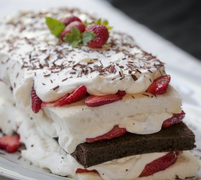 Neapolitan Cake With Fresh Strawberries layers chocolate and vanilla cake with sweetened, stabilized whipped cream and fresh strawberries. Photo by John Sykes Jr.
