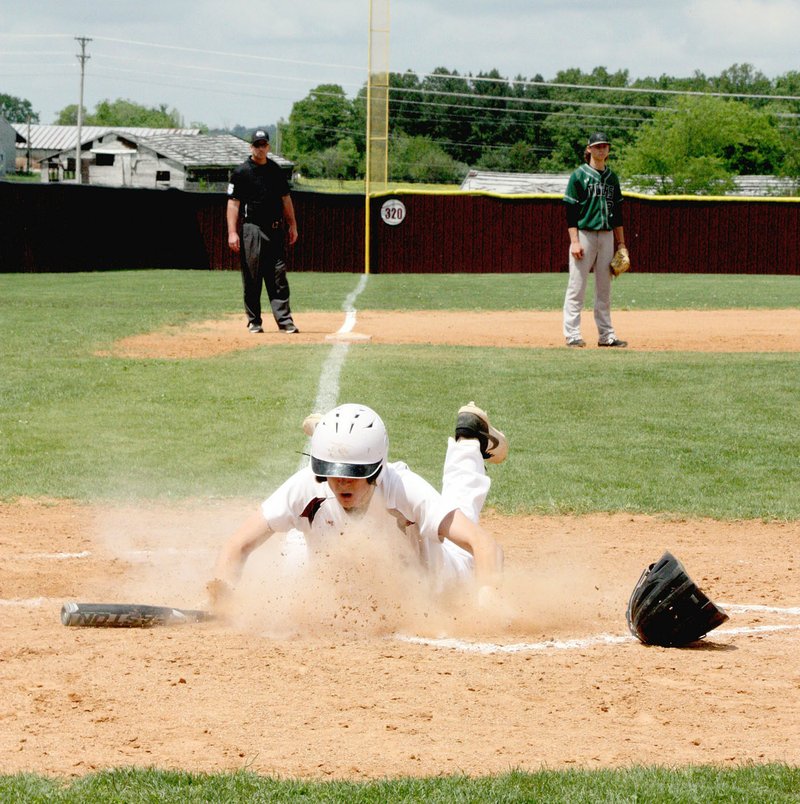 MARK HUMPHREY ENTERPRISE-LEADER/Lincoln senior Sterling Morphis slides into home scoring the winning run during a dramatic seventh inning win for Lincoln over Valley Springs, 4-3, Thursday in the first-round of the 3A-1 Regional baseball tournament. The win allowed the Wolves to gain a state tournament berth this week.