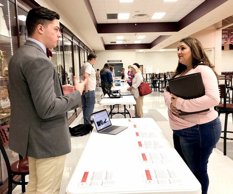 Janelle Jessen/Herald-Leader Senior Jacob Reprogle spoke to Veronica Handcock, talent acquisition manager for Simmons Foods, during the reverse career fair on Friday. A total of 20 students and 13 employers participated in the event.