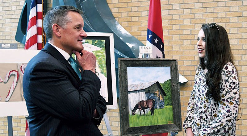 The Sentinel-Record/Grace Brown ART COMPETITION: U.S. Rep. Bruce Westerman, R-District 4, left, speaks to Woodlawn High School senior Maggie Gavin about her artwork on Friday at the Hot Springs Convention Center.