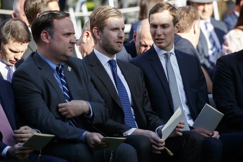 White House Social Media Director Dan Scavino, left, Eric Trump, center, and White House senior adviser Jared Kushner wait for the arrival of President Donald Trump to present golfer Tiger Woods with the Presidential Medal of Freedom, in the Rose Garden of the White House, Monday, May 6, 2019, in Washington. (AP Photo/Evan Vucci)