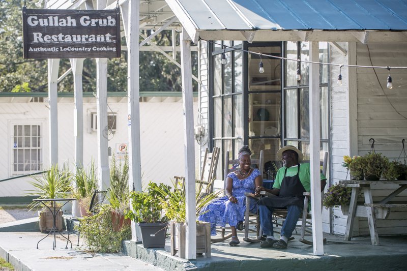 Bill and Sara Green sit on the porch at Gullah Grub, their restaurant on St. Helena Island, S.C. The Gullah Geechee culture on the island has endured since the days of slavery. Photo by Hunter McRae via The New York Times