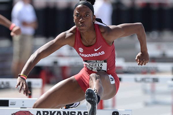 Arkansas' Janeek Brown clears a hurdle Saturday, April 27, 2019, while competing in the 100-meter shuttle hurdles during the National Relay Championships at John McDonnell Field on the campus of the University of Arkansas in Fayetteville.