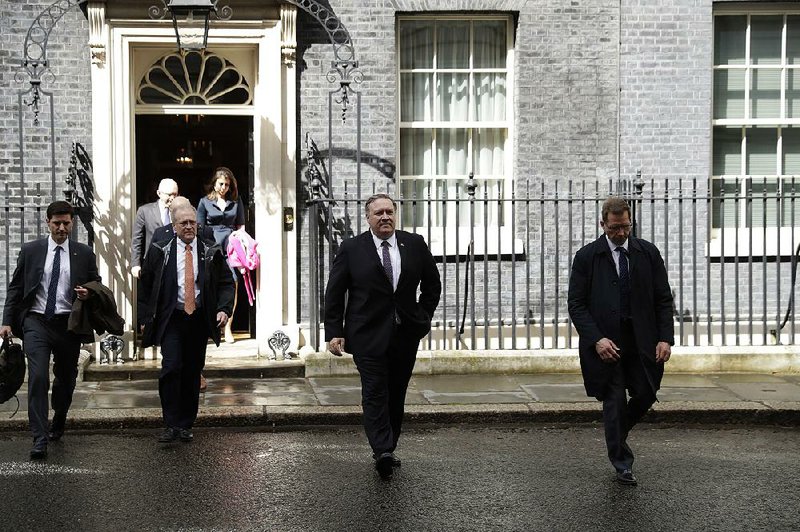 Secretary of State Mike Pompeo (second from right) leaves No. 10 Downing St. in London after meeting Wednesday with British Prime Minister Theresa May. 