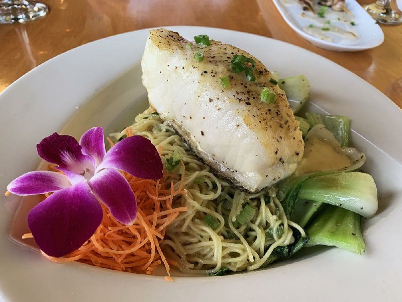 The Chilean sea bass, with baby bok choy, lemon grass vinaigrette and ginger scallion noodles, is the premier entree at Kemuri sushi, seafood, robata. 