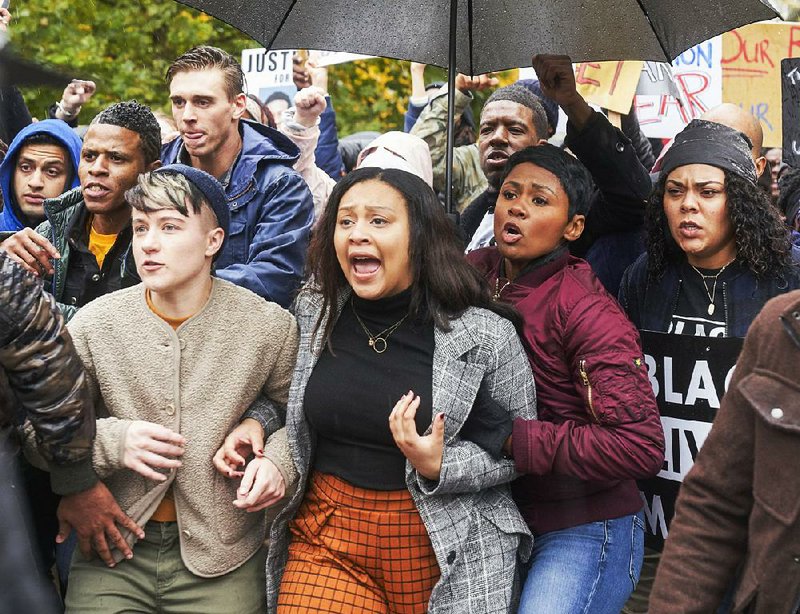 Aliyah Royale (center) portrays Jira Calder-Brennan in a scene from the CBS-TV limited series The Red Line. 