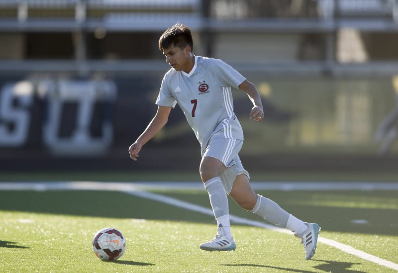 NWA Democrat-Gazette/CHARLIE KAIJO Springdale High midfielder Nelson Barroso (7) dribbles during a soccer game, Friday, March 15, 2019 at Bentonville West in Centerton. Barroso helped the Bulldogs win the 6A-West Conference title. Springdale will open 6A state soccer tournament play at 10 a.m. Friday in Conway.