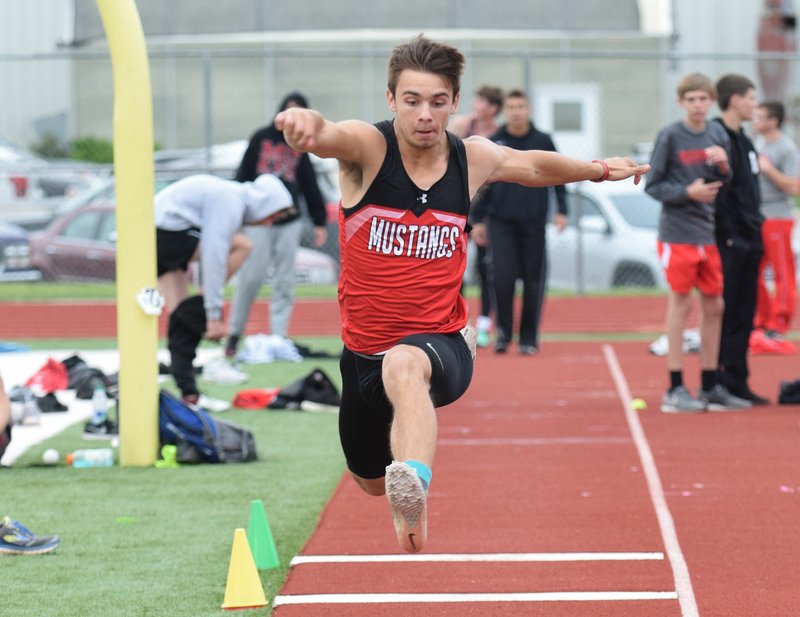 RICK PECK/SPECIAL TO MCDONALD COUNTY PRESS McDonald County's Corbin Jones jumps his way to a school record of 43-10.75 to win the triple jump at the Big 8 Conference Track and Field Championships held May 2 at Mount Vernon High School.