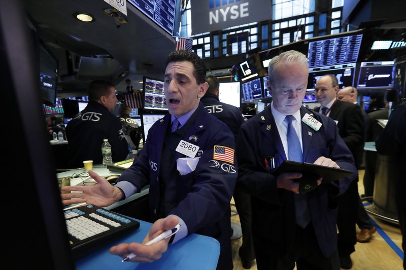  In this March 11, 2019, file photo specialist Peter Mazza, left, and trader James Riley work on the floor of the New York Stock Exchange.  (AP Photo/Richard Drew, File)